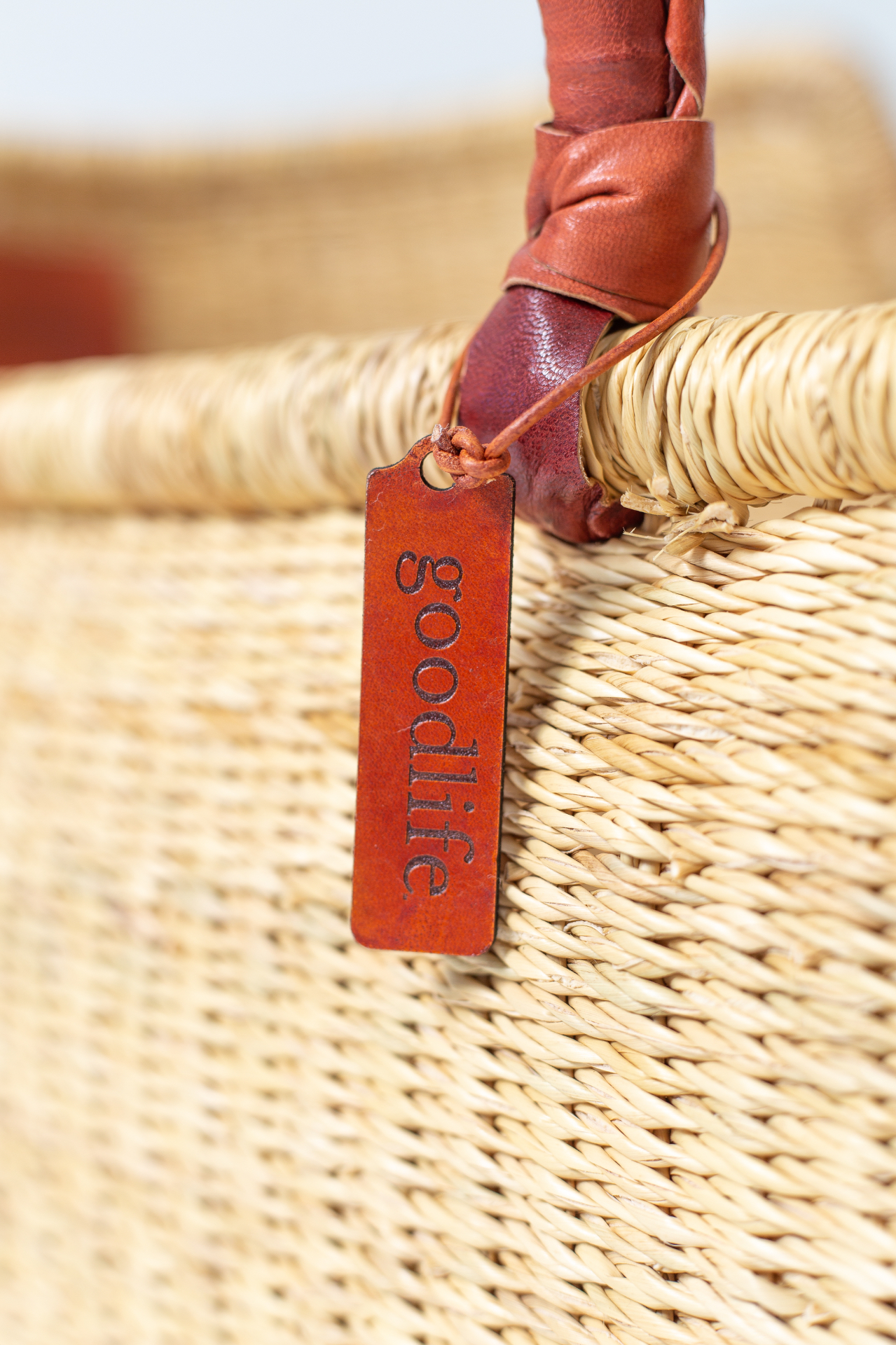 Hand-stamped Goodlife Baby leather tag on a woven Heirloom handle