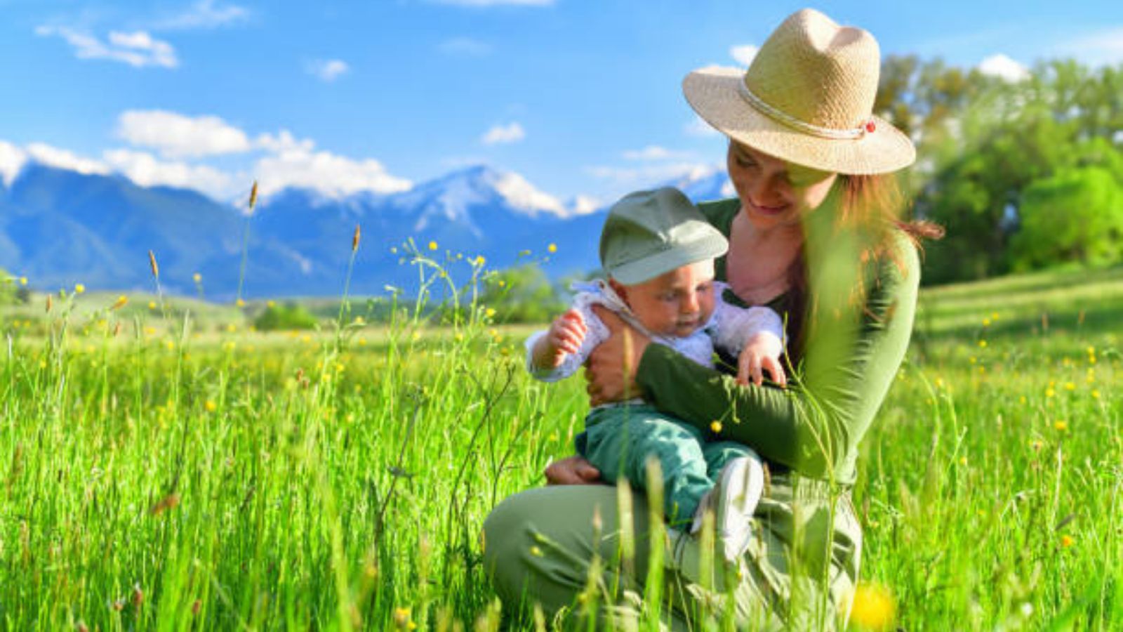 A mother and her baby in a sunny mountain meadow